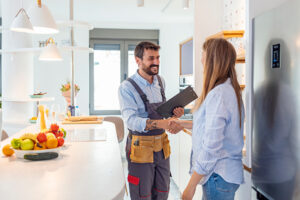 woman speaking to electrician during electrical tune-up appointment.